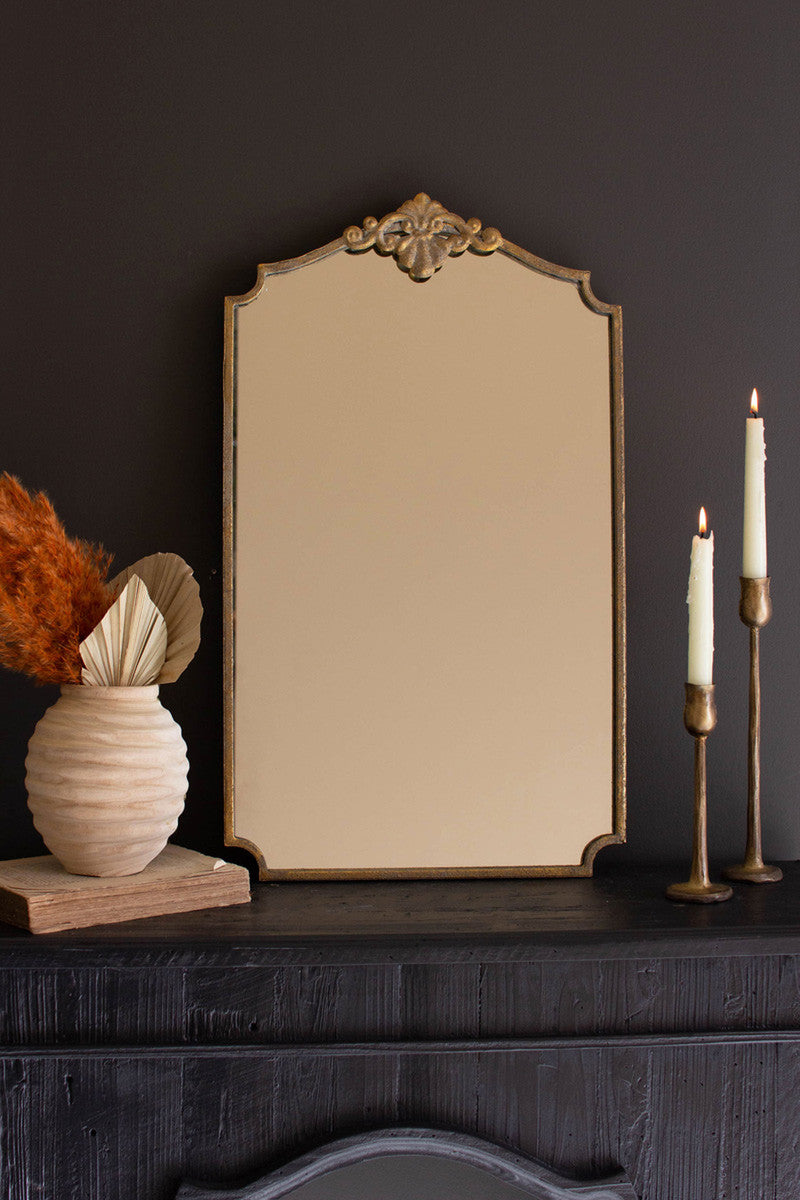 Prop or hang this dressing mirror with a top medallion accent and cut corners. This elegant mirror suits fancy or plain spaces. Add a touch of opulence with this fancy gold-framed mirror. 16" x 27"t