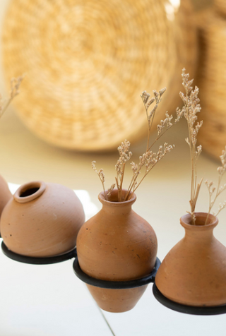 Eight Clay Vessels on an Iron Base